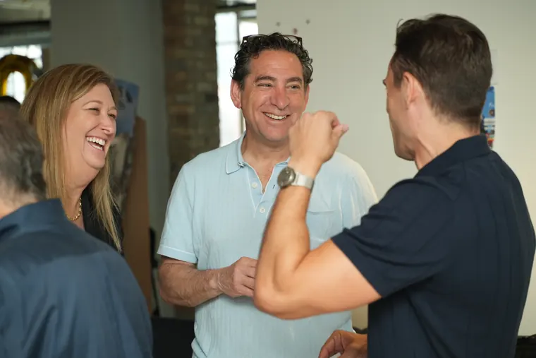 Three attendees laughing together in Chicago