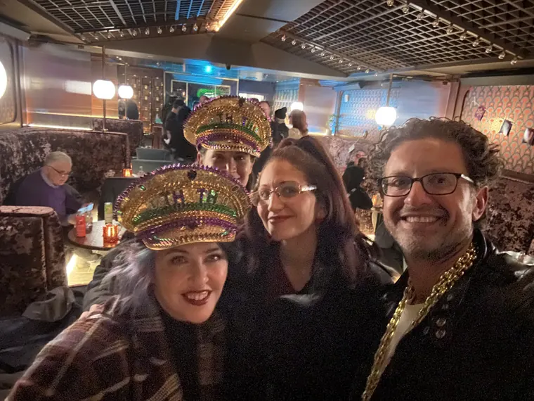Guests in gold captain's hats with Jordan Isenstadt at the Purim party